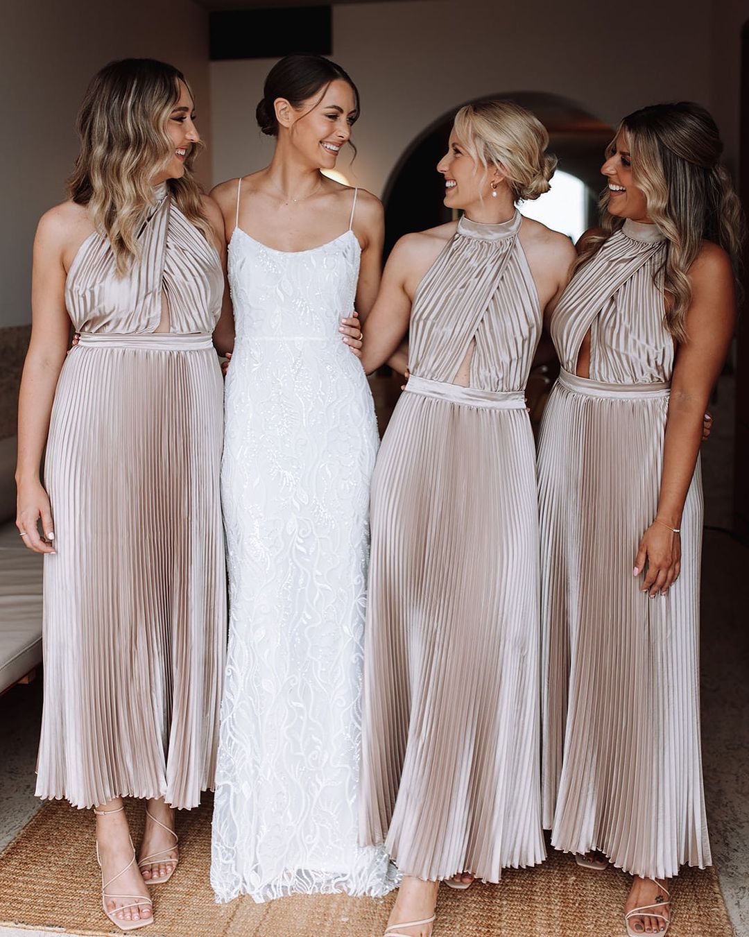 Four women in elegant bridesmaid dresses