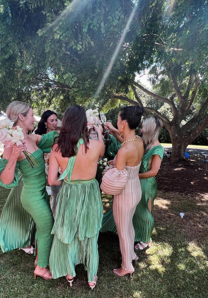 Bridesmaids in a mix of green and white dresses