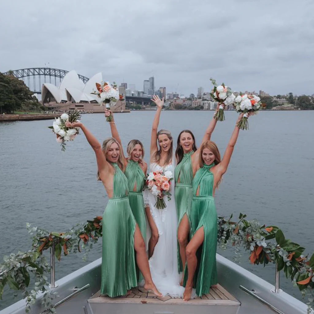 Bridesmaids in green dresses on boat 