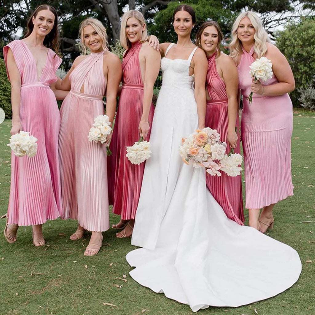 A group of bridesmaids in pink dresses, standing together and smiling